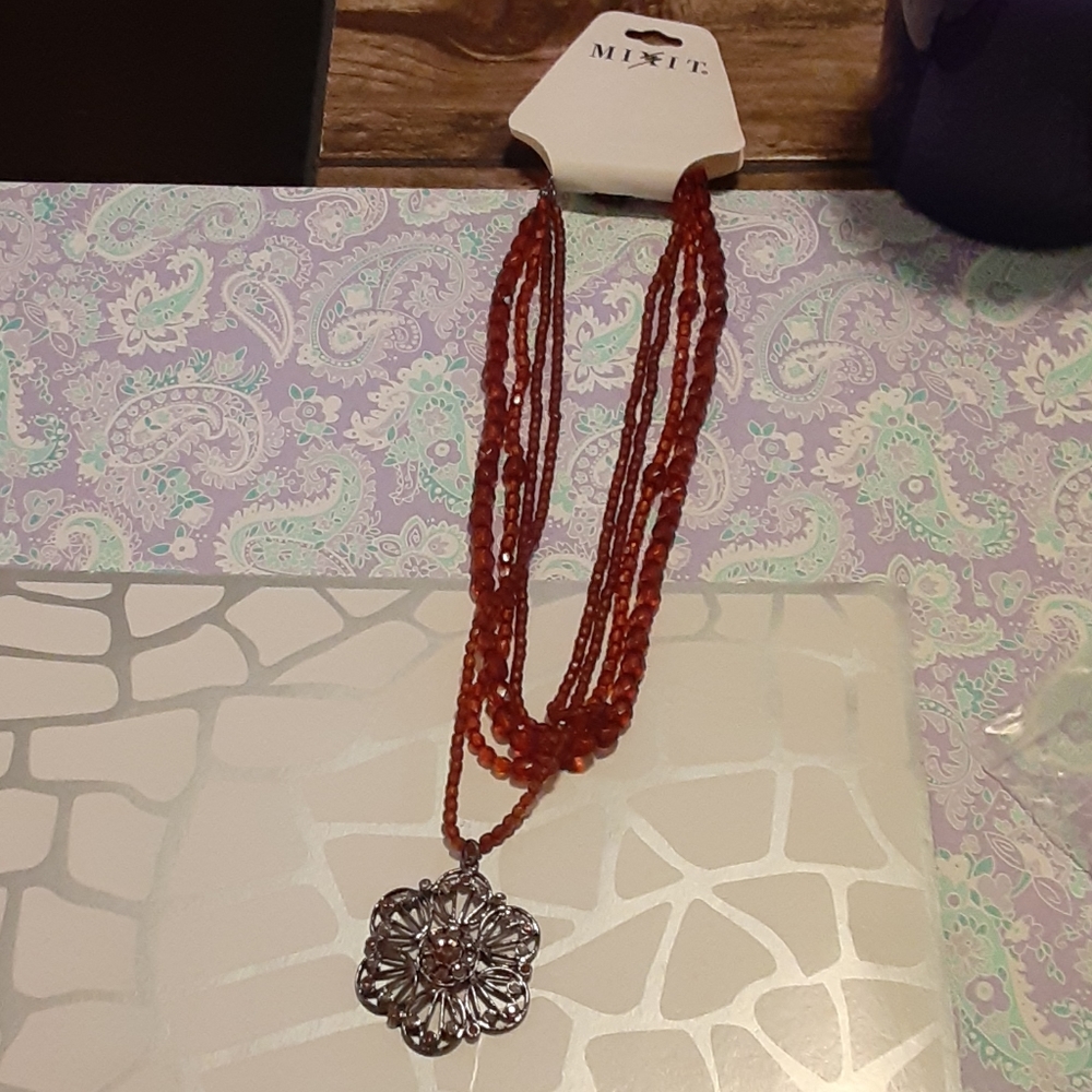 Necklace with silver flower.